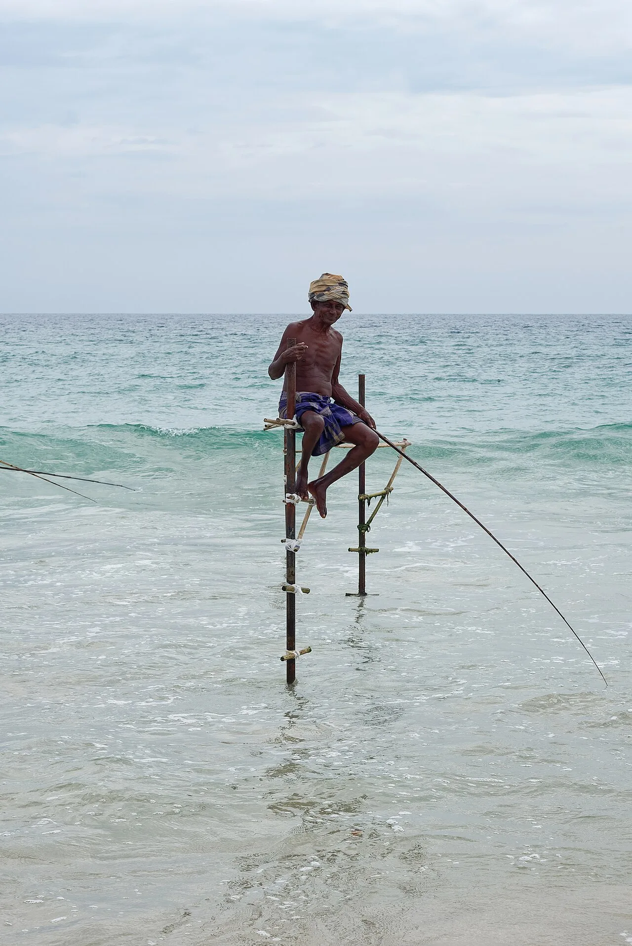 Koggala - Fisherman practicing traditional stilt fishing in Koggala near Galle, southern Sri Lanka